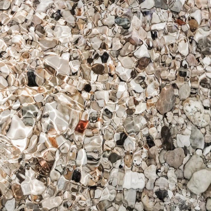 Stones in crystal clear mountain river