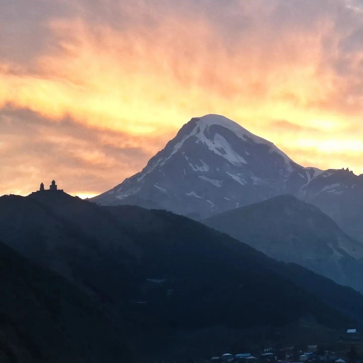 Mount Kazbek and Gergeti Trinity Church in the evening